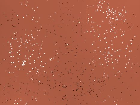 Confetti stars sparkling on orange background.