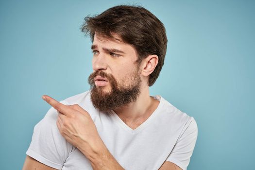 Bearded man emotions white t-shirt lifestyle gestures with hands blue backgrounds. High quality photo