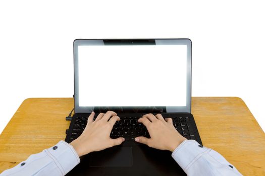 Closeup of women's hands touching type notebook (laptop) keys during work business on wooden table isolated on white background.