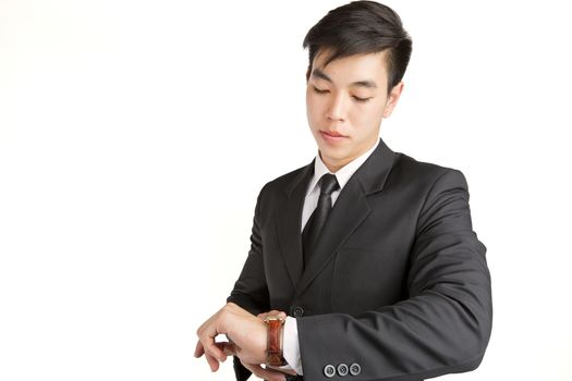 Young Businessman checking the time on his wrist watch : hurry time