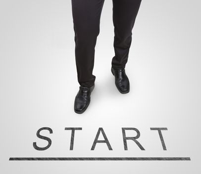 Businessman standing wearing court shoes on start(begin) line.