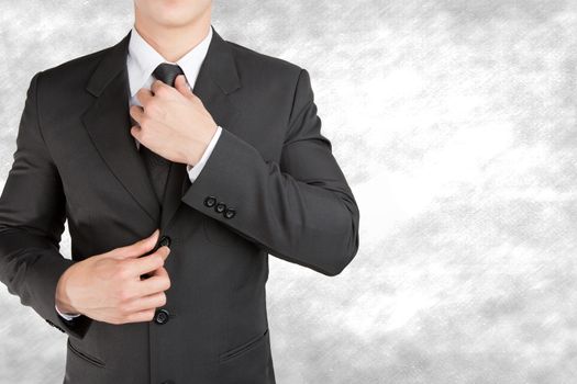 Well dressed businessman looklike smart adjusting  his neck tie on  background : fill text