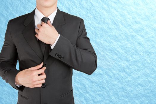 Well dressed businessman looklike smart adjusting  his neck tie on sky background : fill text