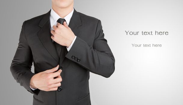 Well dressed businessman looklike smart adjusting  his neck tie : fill text