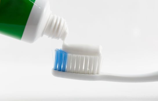 Hand press Toothpaste on tooth brush.