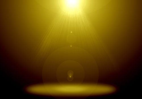 Abstract image of gold lighting flare on the floor stage.