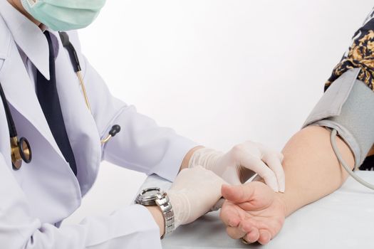 Doctor checking pulse of patient with stethoscope  on table isolated white background. 