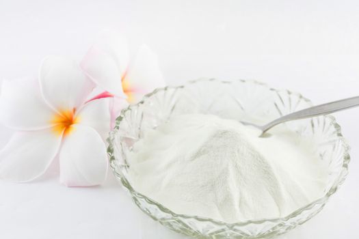 Collagen powder protein on spoon measure isolated on white background.