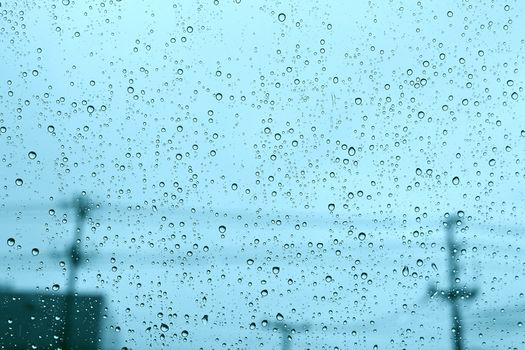 Windshield rain drop car window on blue daylight.
