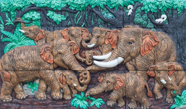 Nakhonnayok, THAILAND - May 3, 2015 : Antique decorate wall : Elephants playing in the forest.