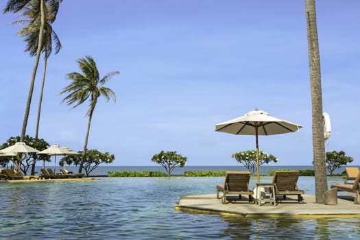 Perfect beach swimming pool with tropical resort relax.