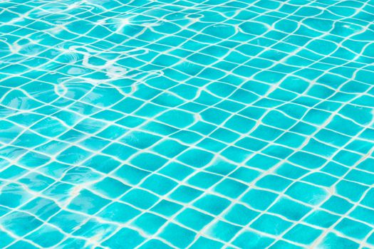 Blue sky swimming pool water texture reflection.