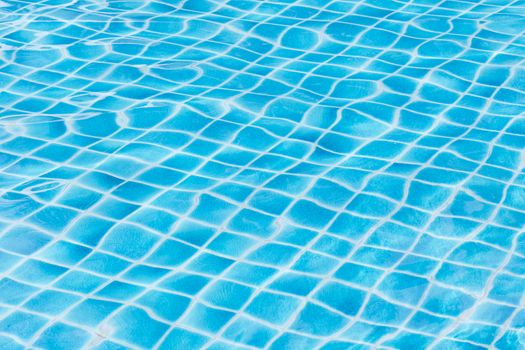 Blue sky swimming pool water texture reflection.