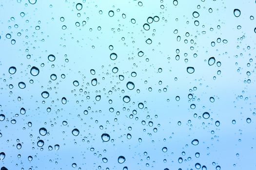 Water drop on glass mirror background.