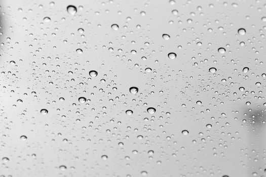 Water drop on glass mirror background.