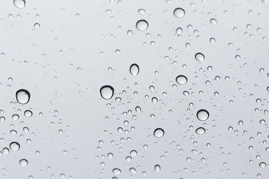 Water drop on glass mirror background.