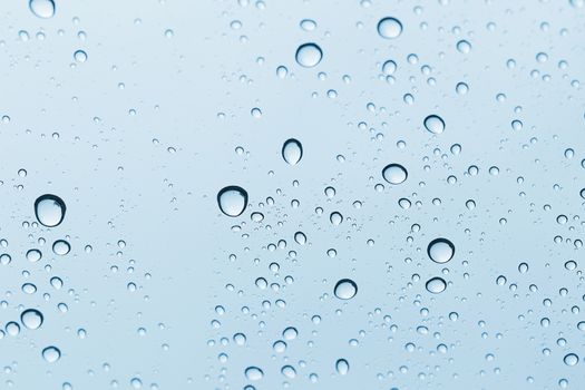 Water drop on glass mirror background.