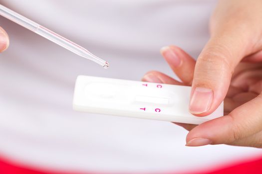 Young women checking pregnancy test.
