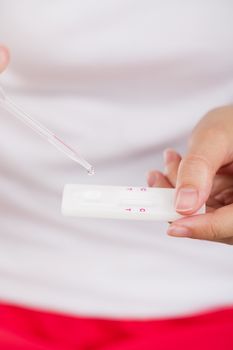 Young women checking pregnancy test.