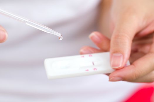 Young women checking pregnancy test.