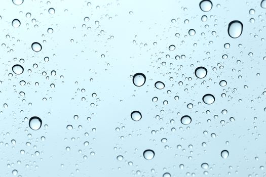 Water drop on glass mirror background.