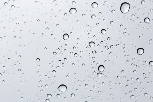 Water drop on glass mirror background.