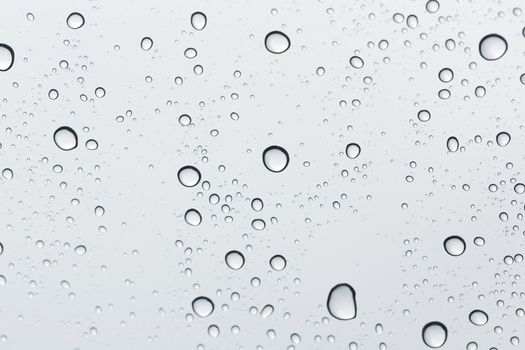 Water drop on glass mirror background.