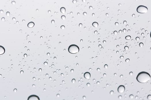 Water drop on glass mirror background.