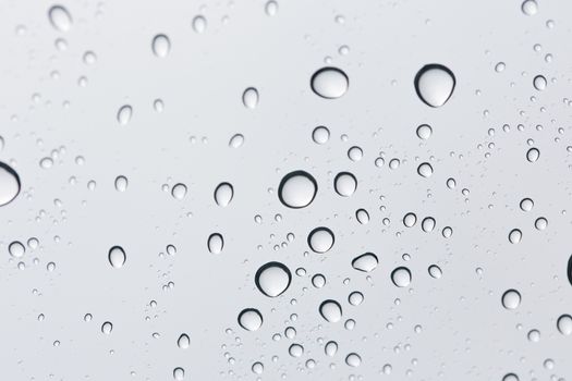 Water drop on glass mirror background.