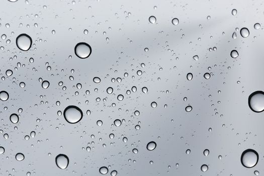 Water drop on glass mirror background.