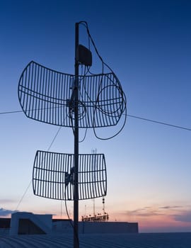 Antenna silhouette on sunset.