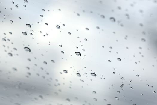 Water drop on glass mirror background.