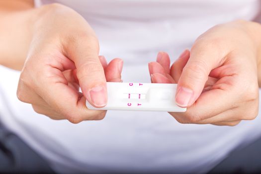 Young women checking pregnancy test.