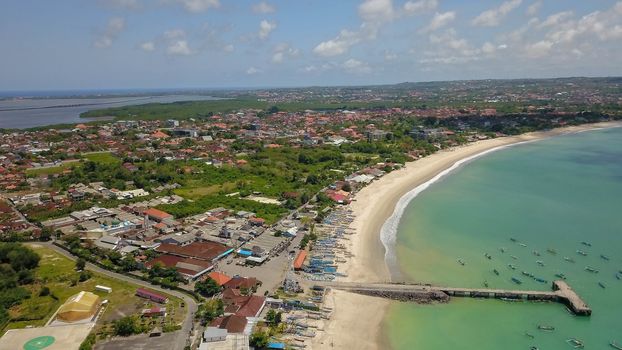 Aerial Drone Flight above Turquoise Crystal Ocean Water, Harbor, Port, Pier in Bright Sunny Day Light. Travel Transport Relax Tourism Concept. Tropical Paradise Bali Island, Indonesia. Cinematic.