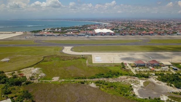 Airplanes at Balinese airport, Bali island, Indonesia. Aerial view to Ngurah Rai airport.