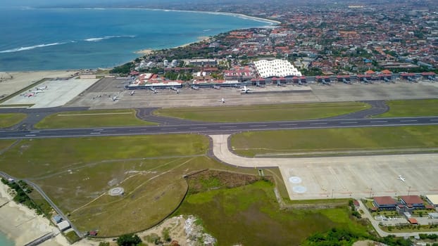 Airplanes at Balinese airport, Bali island, Indonesia. Aerial view to Ngurah Rai airport.