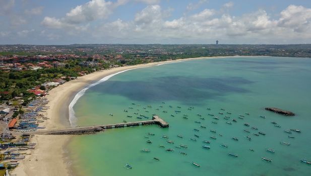 Aerial Drone Flight above Turquoise Crystal Ocean Water, Harbor, Port, Pier in Bright Sunny Day Light. Travel Transport Relax Tourism Concept. Tropical Paradise Bali Island, Indonesia. Cinematic.