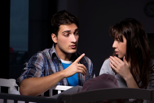 Young parents sleepless with newborn baby at night