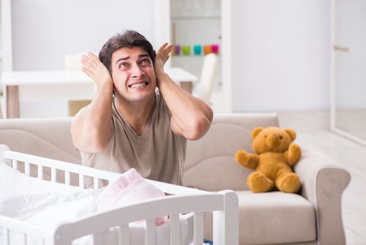 Young father dad frustrated at crying baby