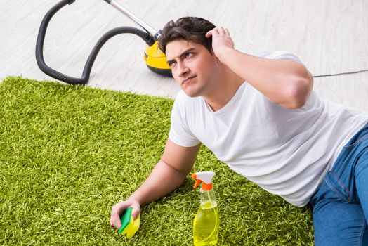 Young husband man cleaning floor at home