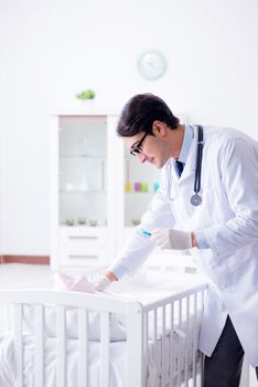 Doctor preparing for baby vaccination
