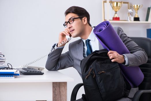 Young businessman rushing to sports gym during break