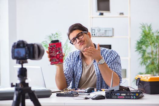Vlogger recording computer repair on camera for vlog blog