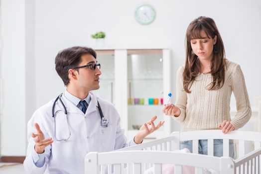 Doctor explaining to young mother 