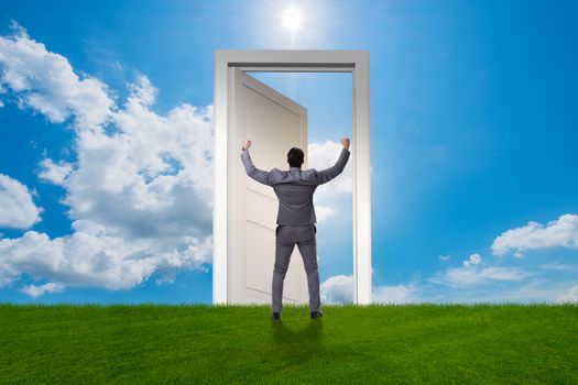 Businessman standing in front of door into future