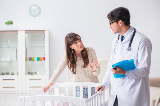 Doctor explaining to young mother 