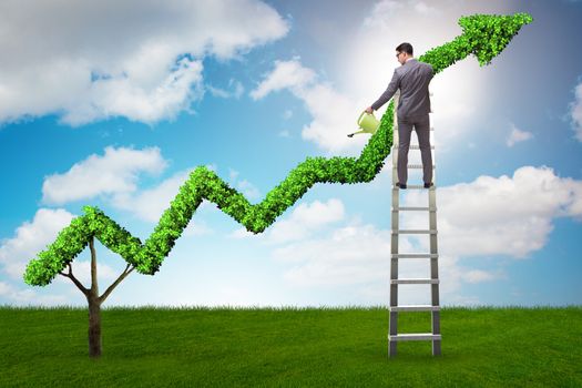 Businessman in investment concept watering financial line chart