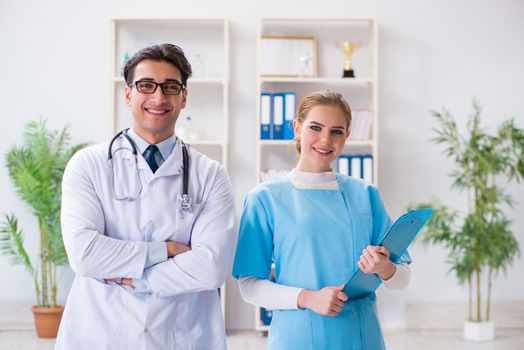 Male and female doctor having discussion in hospital