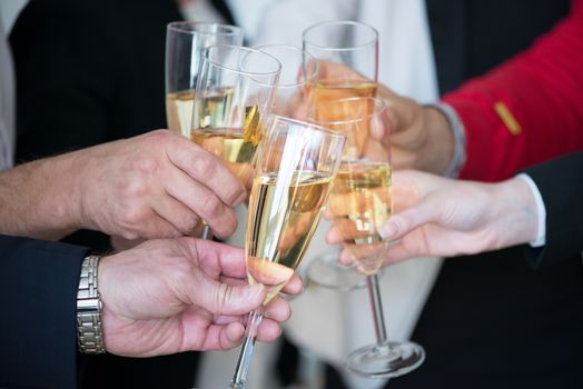 Business people drink champagne celebrating New Year at office party