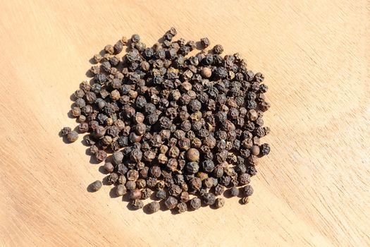 healthy and spicy Black Pepper stock on wooden background